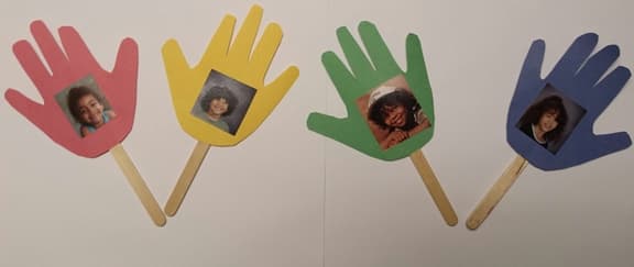 These traced-hand photo displays can be "planted" in small pots of dirt or marbles to resemble flowers.