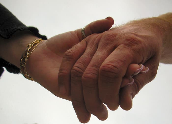 A couple holding hands signifies good companionship that can last a lifetime.