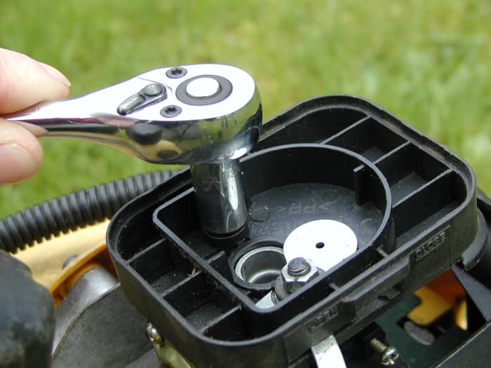 Remove the retaining nuts with a socket wrench.