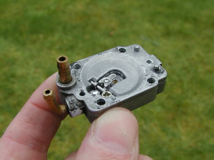 The diaphragm assembly consists of a needle valve, metering lever/rocker arm, and spring.