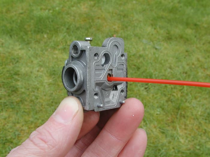 Clean the jet. An air blow gun is invaluable for clearing a complete blockage in the the jet if you don't have any carb cleaner.
