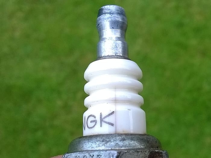 Hairline cracks in the insulation of plugs can short out high voltage and result in no spark across the gap.