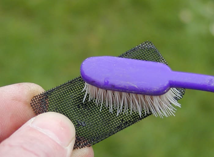 Clean the screen with an old tooth brush, wire brush, or compressed air.
