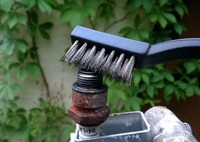 A "toothbrush" style wire brush is useful for cleaning soot from a spark plug.