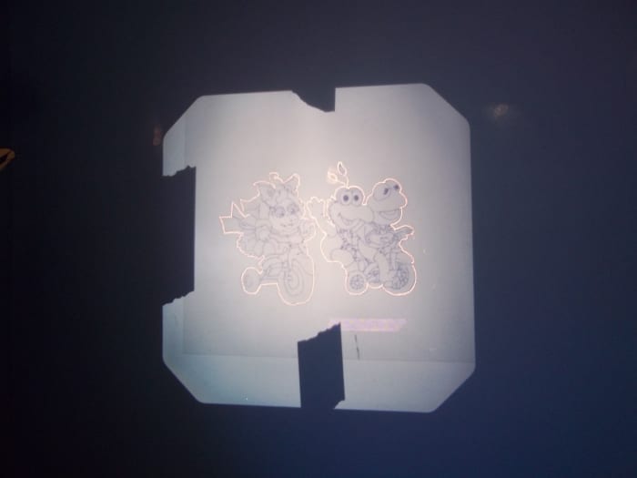 First we outlined the outermost portions of the picture with white chalk. You can see here we taped the transparency so it would stay in place during this process.