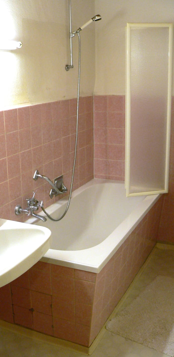 Note the wall bar mount. This allows showerhead height to be adjusted. It also makes it easier to grab the handheld for those who need to hold onto the bar while showering. Home Depot advertises the bracket, as do other plumbing stores.