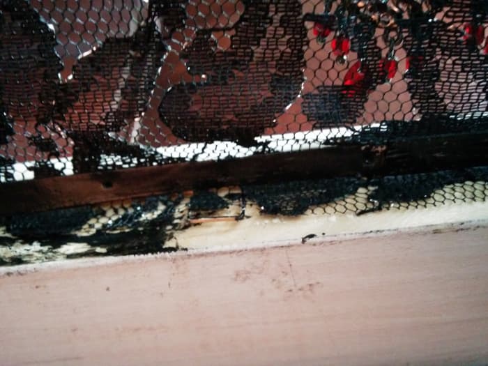 The glued-down lace on the inside of my frame. I painted the cardboard black after gluing to make it less visible against the black lace.