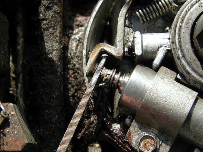 Clean any tarnish and pitting from the points with a fine cut file or fine sandpaper. Take care, as the points are coated with special material to withstand arcing. Only lightly file. If you overdo it with the file, you'll end up removing the coating