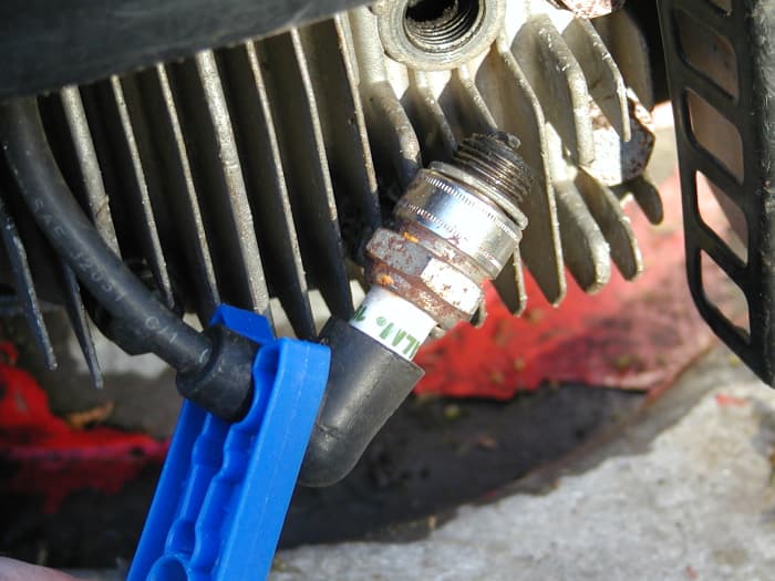 Hold the spark plug against the cylinder head and pull the starter cord to check for a spark. You may need an assistant. A plastic clothes peg may be a good idea to prevent shock in case the lead is damp!