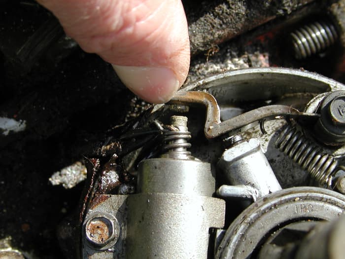 The points gap is set on this Briggs and Stratton engine by loosening the bolt and moving the capacitor. It should be about 0.02 inch (check it with a feeler gauge).