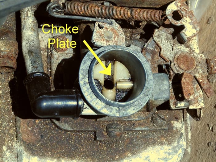 Carburetor air intake showing choke plate (air filter has been removed) on a small 3 1/2 HP Briggs and Stratton engine.