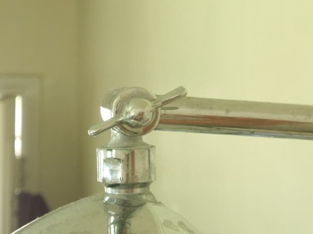 The one on the left lets you adjust the position of the showerhead itself. Just loosen the knob, move the showerhead to where you want it, and tighten the knob again to hold it in place.