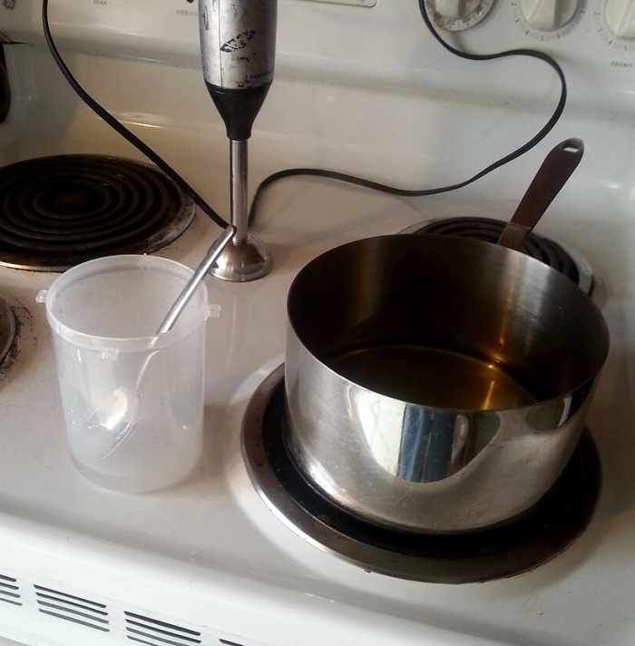 Lye water mixture and pan of melted coconut oil, ready to mix