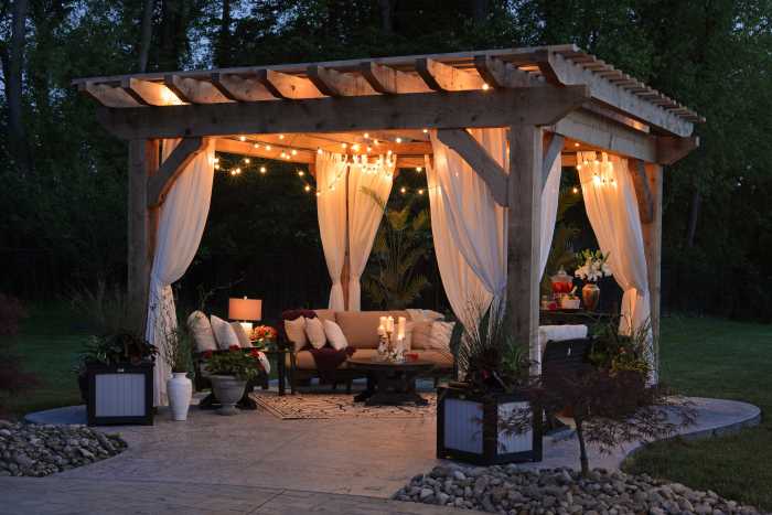 Romantic getaway in your own backyard.  A pergola with flowing drapery