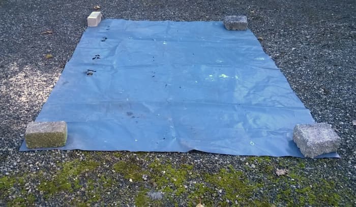 A large sheet of polythene keeps the ground clean, prevents contamination of the concrete by leaves,mud and other debris and you can scrape up all the leftovers