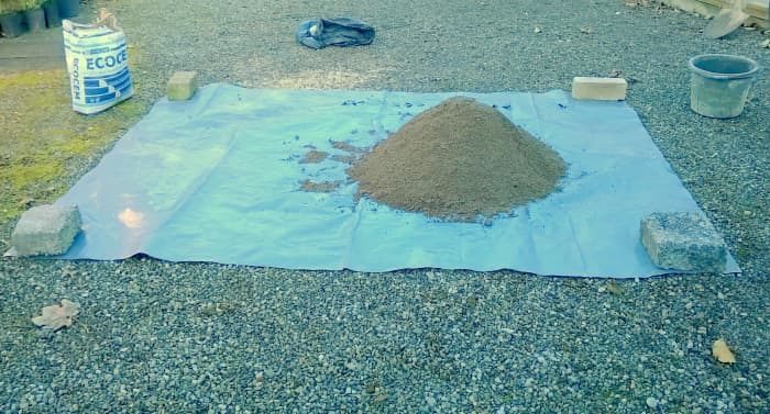 Measure out the stone first and add the sand on top. Keep the pile to one side of centre so you can mix sideways
