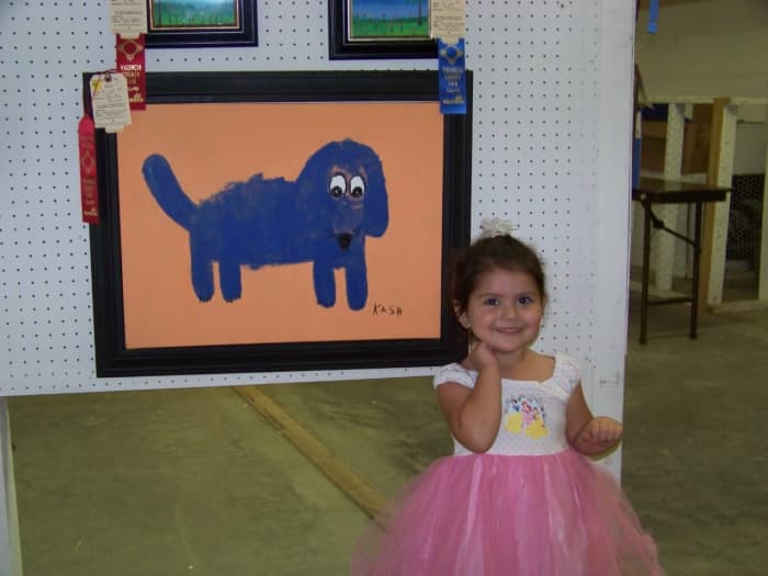 For her "Blue Dog Art" Painting, 2 year old, Kash, placed 2nd in the Tiny Tots Division. Kash sees her ribbon for the her blue dog painting! This is her first large sized acrylic painting.