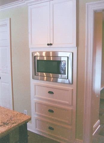 Microwave built-in, flush on the wall.