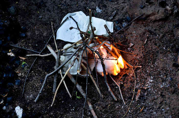 Dry scraps of paper, cotton, or wood are commonly used to get any type of fire going.