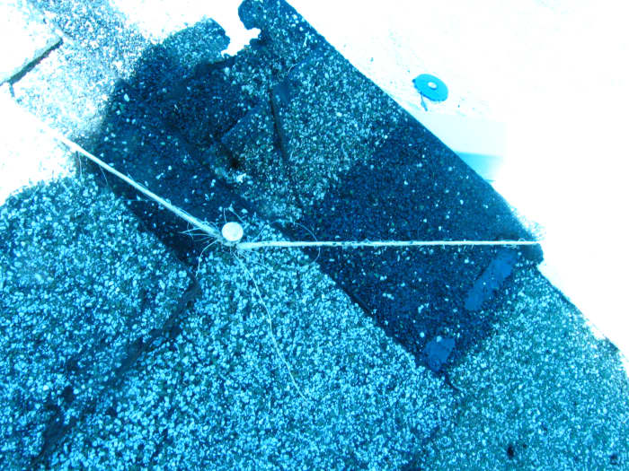Nailing a string and running it from the corner top to the outside edge, corner at the bottom will make the ridge center