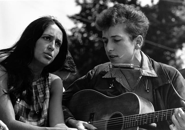 Bob Dylan with Joan Baez. Dylan had a romance with Baez in the early 60s and she helped to bring him increased public exposure. Later, she wrote the song Diamonds and Rust about their romance.