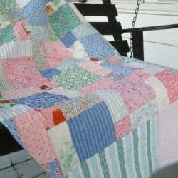 For this quilt, I used a fat quarter bundle to create a boat load of random disappearing nine-patch squares that are framed by mitered borders.