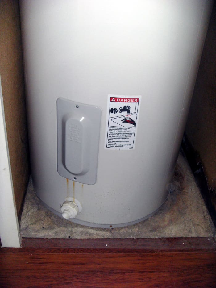 Drain valve on the bottom of the water heater. One side cover plate for heating elements is also shown.