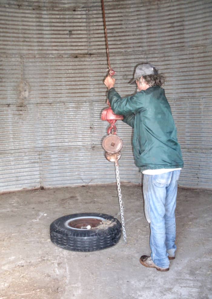 Attach lifting ring. There is such a thing as a specially-made lifting ring, but the one we commonly use is a large truck tire with a securely fastened log chain around it.