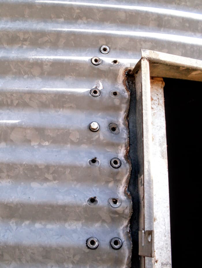 Leave one bolt at the top until last, so you can control until the last second how stable the doorframe is.