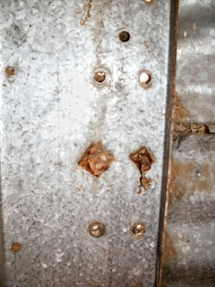 On many older bins, there are a variety of fasteners. Sometimes, they are rusted past loosening. You may need a torch for situations like this.