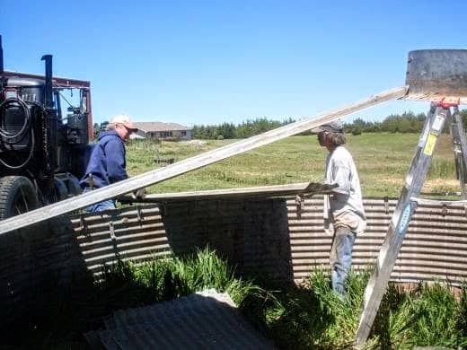 Once you are down to a few sheets, you will need to rest the centers of the roof sheets on the ladder.
