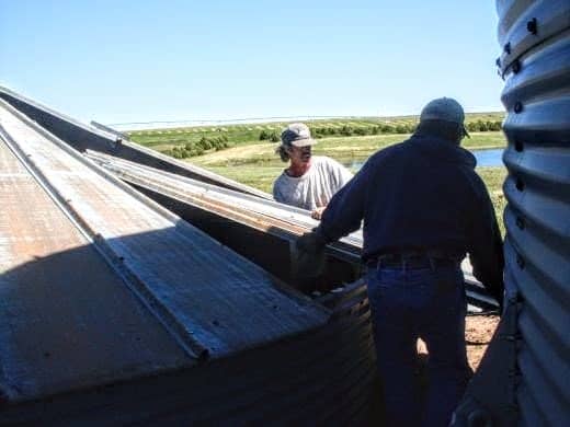 Remove top bolt only when ready to remove sheet, then slide sheet down and out, placing it on your roof sheet pile.