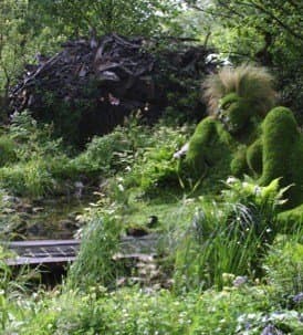 This stumpery cave by artist Phillip Game is made of driftwood. It was one of the main features of "The 4head Garden of Dreams," which won the Chelsea Flower Show Silver-Gilt Award in 2006.