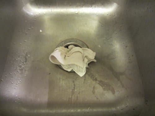 A towel, wad of paper towels, your daughter's knitted hat: anything will do so long as it keeps the bubbles in your drain, not filling your sink.