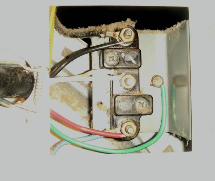 The white wire is placed on the center terminal, where it belongs. The ground strap has been removed and the green wire attached to where it mounted on the frame of the dryer.