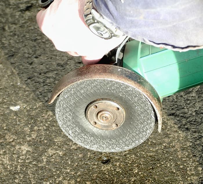 The guard prevents sparks or shattered disk fragments from being thrown up towards the operator. It also prevents your hand making contact with the disk.