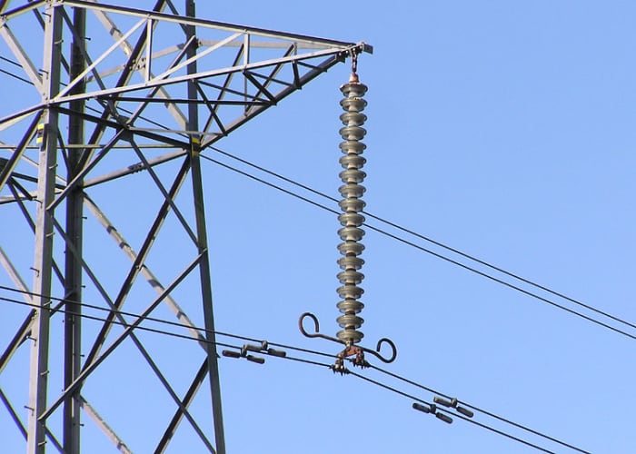Detail of the insulator string (the vertical string of discs) on a 275,000 volt electricity pylon near Thornbury, South Gloucestershire, England.
