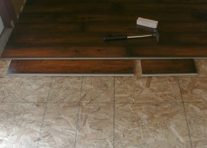 This is one piece that has been cut; it is lying in the orientation that it will be installed. The first piece will be the short end; it has a cut surface to the left that will fit against the threshold to the left.