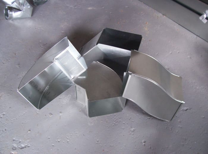 Photo 4: Duct fittings (duct 90 on left, duct 45 bottom center, transition top center, and riser on right) just a few examples of duct fittings.