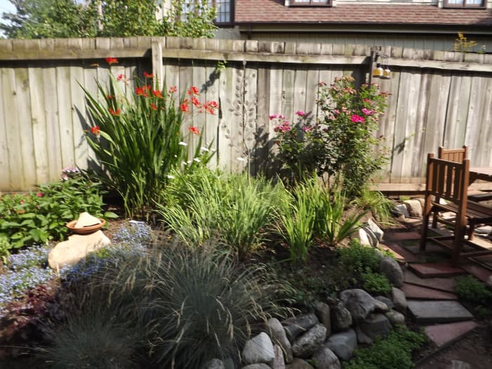 The entire garden isn't shown. It is planted all along the fence. Placing a table in the area can provide a nice peaceful place to sit in the summer months.