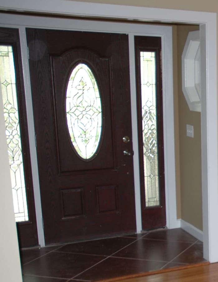 The decorative glass in the door and side lites add interest and a bit of privacy without blocking light. Ornate beveled glass create a "picture" in the door as well as the side lights.