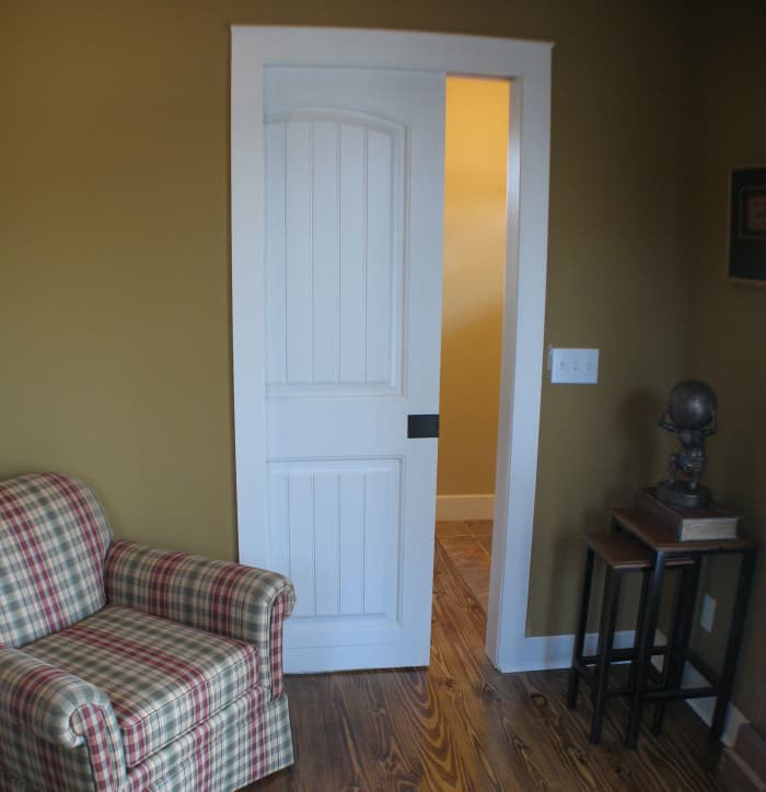 This small study saves space with a pocket door and avoids conflicting with the front door on the other side of the wall.