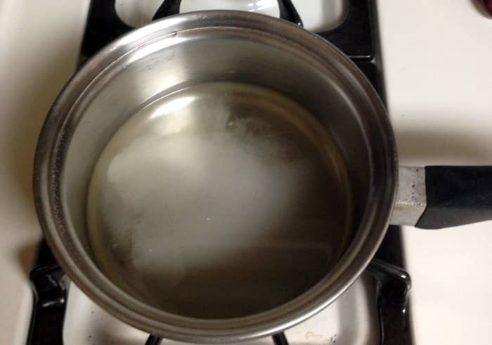 Heat the sugar and water mixture until the sugar dissolves. Alternatively, you may add the sugar to boiling water and turn off the stove, letting the sugar dissolve as the mixture cools.