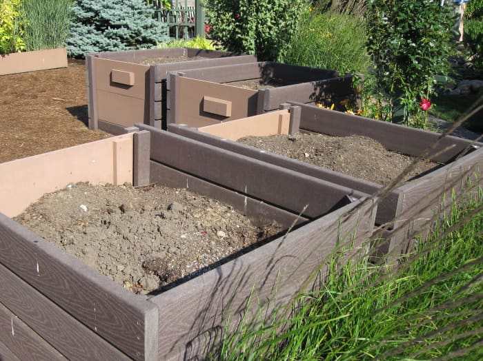 Compost bins are tucked into a corner of the test garden and screened with prairie grasses.