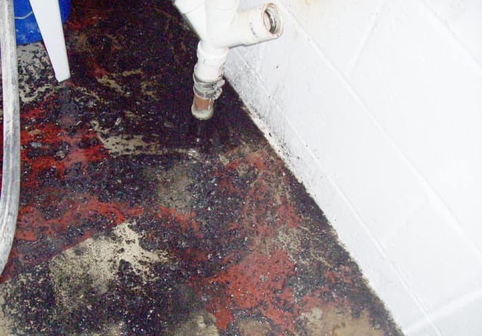 In my case, the clean out is positioned where I cannot get a bucket under it. Therefore, I barricaded the area with towels to contain a mess. Good thing I did as you can see. Not pretty but the job is done and this will clean up.