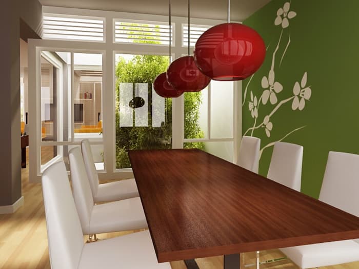 In this room, the long, rectangular dining table mirrors the shape of the space and instills a sense of unity, while the round, hanging light fixtures provide contrast and visual interest.