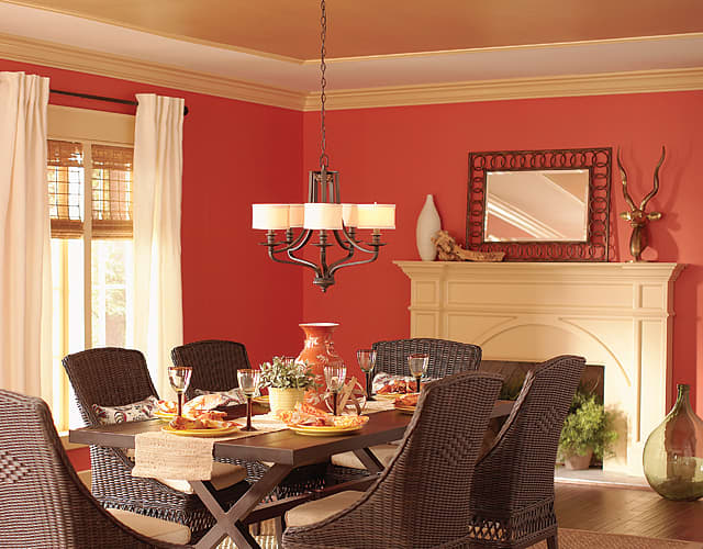This ceiling features gold paint and brings the color down onto the wall with crown molding to visually increase the ceiling height.