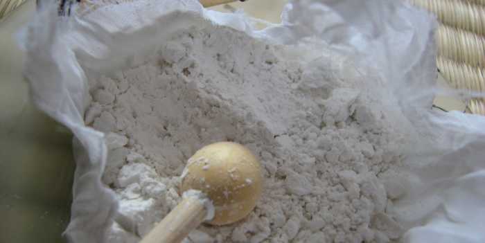 Inside the uchiko (stone-cleaning powder and tapping ball/stick), wrapped in a white silk cloth.