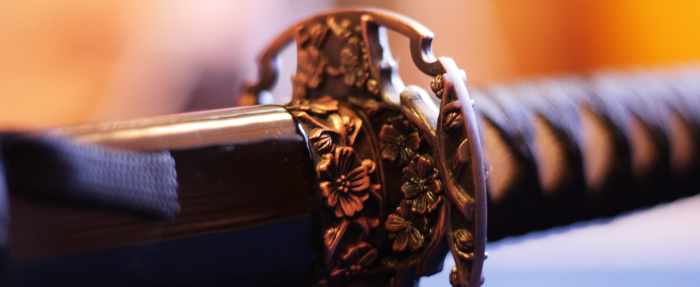 An ornate hilt and scabbard on a Japanese katana.