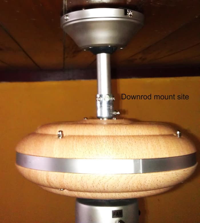 Ceiling-mounted fan motor, showing the downrod mounting site, where there is a pin and two set screws.